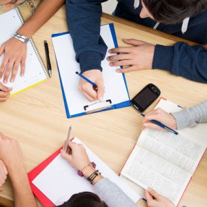 Image of people with notepads and pens