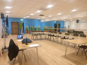 A sport studio set up with tables and chairs in a interview style 