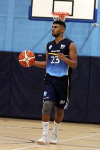 Student Tyrell Catumba holding a basketball