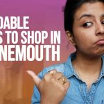 Image of student pointing to text on screen which says Affordable places to shop in Bournemouth