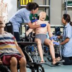 Nursing students practising on dummies in a practice suite