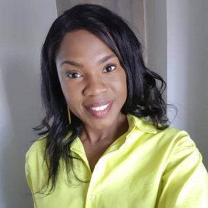 Postgraduate student Nakita poses in a lime green shirt with a big smile in a selfie-style photo.