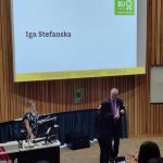 Student Iga in front of a lecture theatre receiving her Graduate Skills +Award