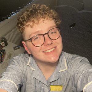 Harrison smiling at the camera wearing skills uniform