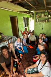 Group of people sitting together on the floor looking up at the camera