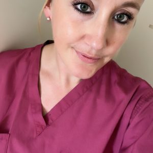 Student in scrubs taking selfie