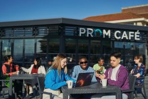 Group of students sitting together at the Prom cafe